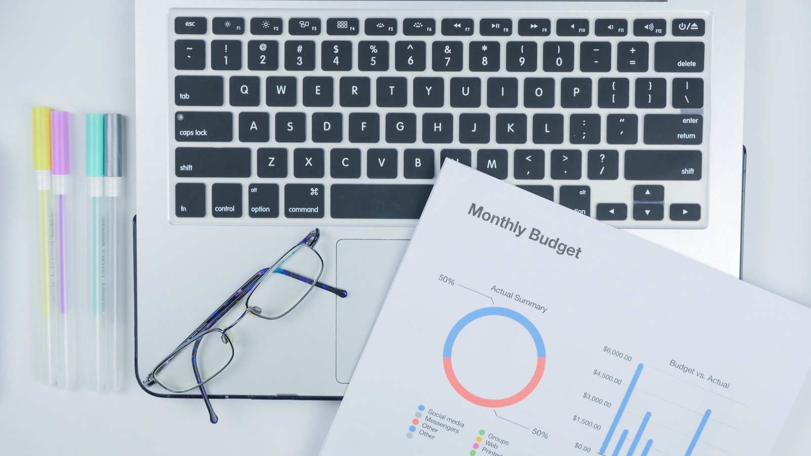 A monthly budget and laptop ready to be organized
